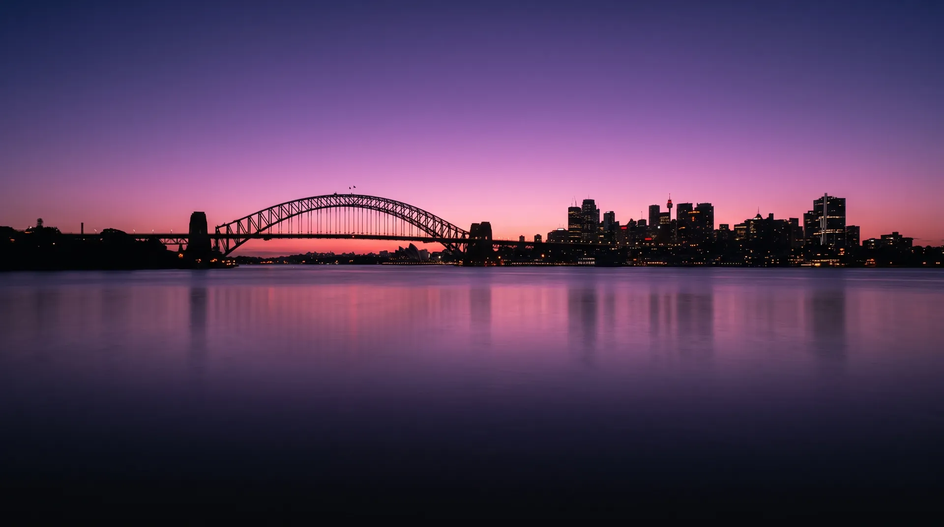 Sydney Harbour at dusk under a violet and pink sky